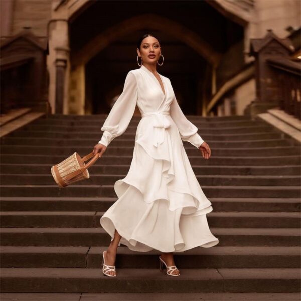 Elegant white satin long-sleeve V-neck dress with a belted waist and ruffle hem, ideal for formal occasions.