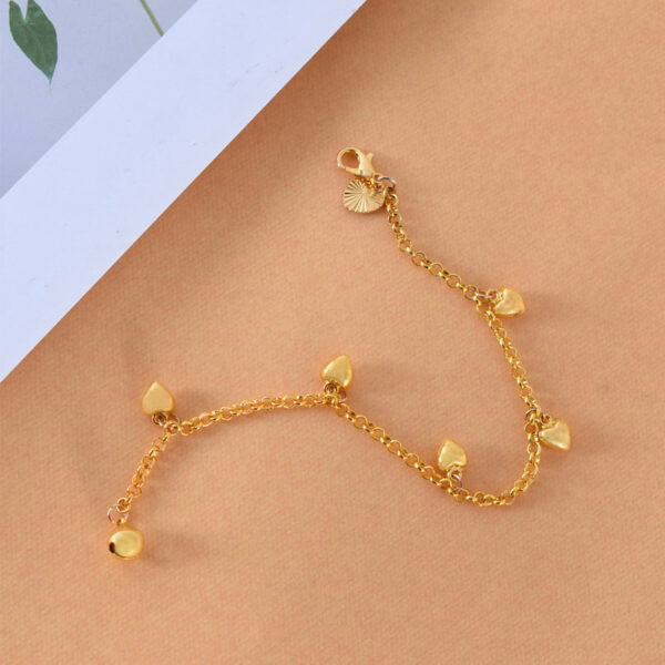 A gold heart charm bracelet with an adjustable chain and delicate heart pendants, perfect for women's fashion jewelry collections.