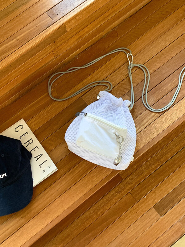 Trendy small mesh drawstring bucket bag with adjustable shoulder strap and front zip pocket, perfect for casual wear.