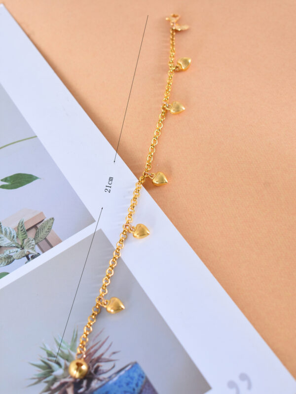 A gold heart charm bracelet with an adjustable chain and delicate heart pendants, perfect for women's fashion jewelry collections.