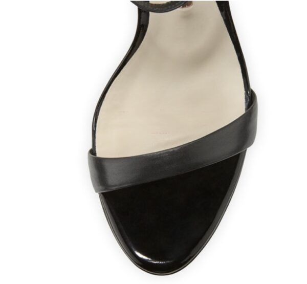 A stylish black stiletto heel sandal with a delicate butterfly wing design at the back, featuring an ankle strap and open-toe style.