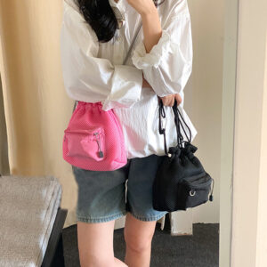 Trendy small mesh drawstring bucket bag with adjustable shoulder strap and front zip pocket, perfect for casual wear.