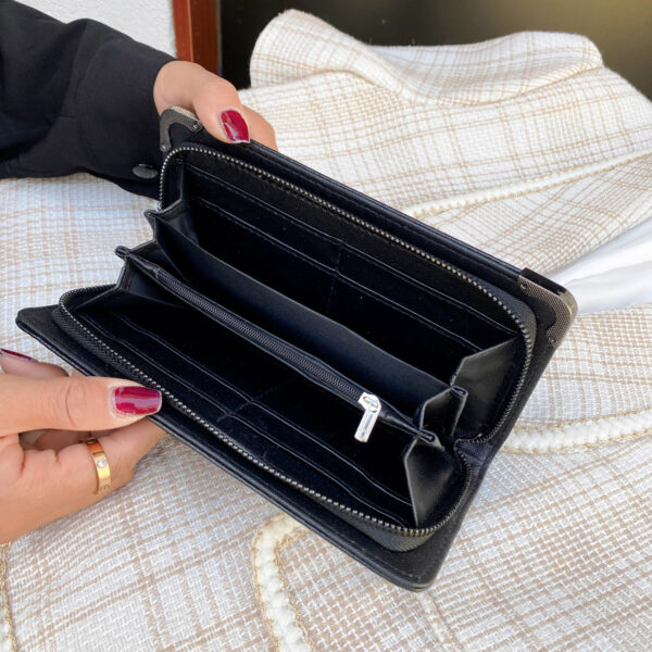 Black gothic skull long wallet for women with multiple card slots and PU leather finish.